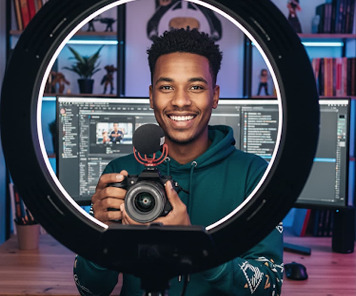 A YouTuber filming to camera with a ring light